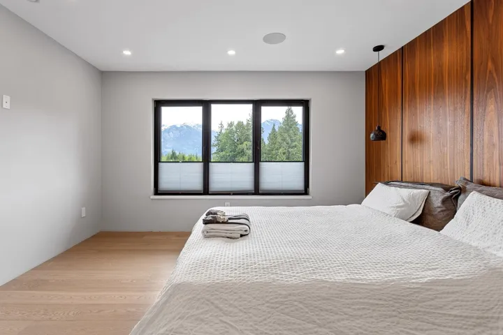 Bedroom with wood finished floors and recessed lighting