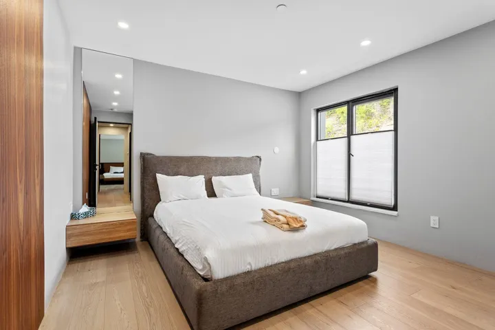 Bedroom with light wood-type flooring and recessed lighting