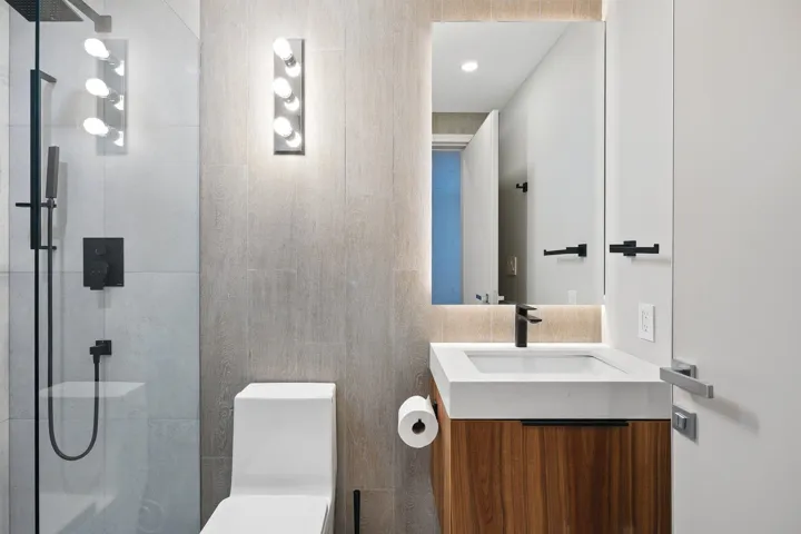 Full bath featuring a shower, toilet, and vanity