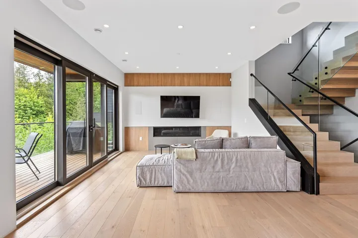 Living area with hardwood / wood-style flooring, stairway, and recessed lighting
