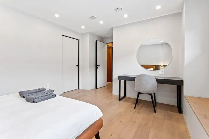 Bedroom with light wood-style flooring, recessed lighting, and a closet