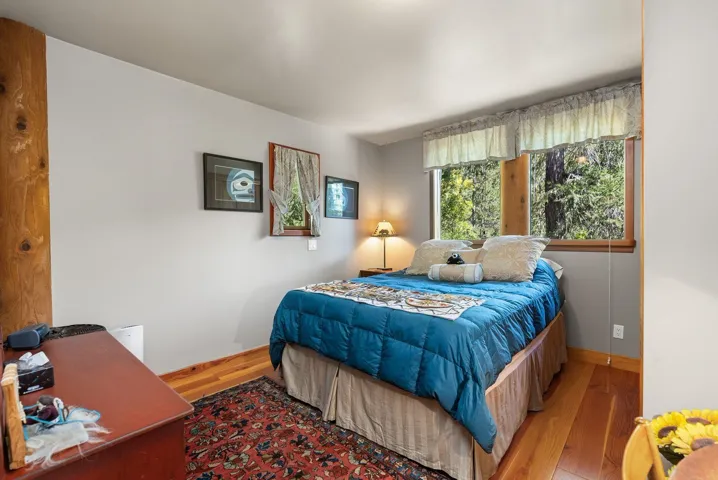 Bedroom with wood finished floors and baseboards