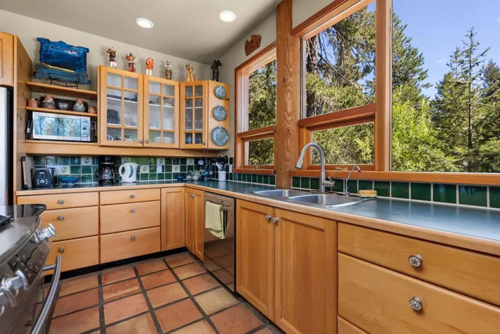 Kitchen featuring backsplash, stainless steel appliances, recessed lighting, glass insert cabinets, and open shelves