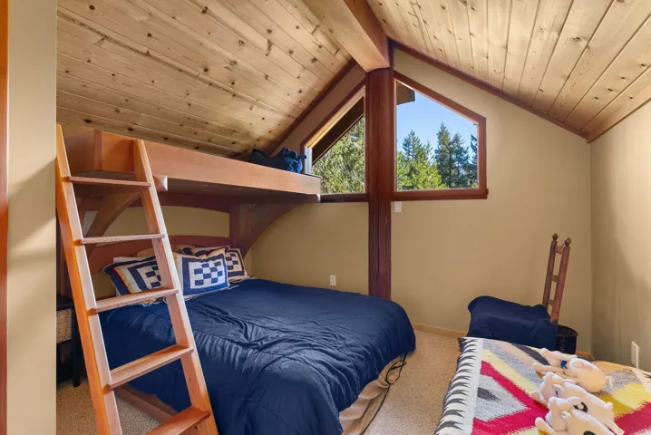 Carpeted bedroom featuring wooden ceiling and baseboards
