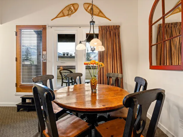 Carpeted dining area with baseboards