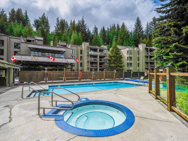 Community pool with a community hot tub and a patio
