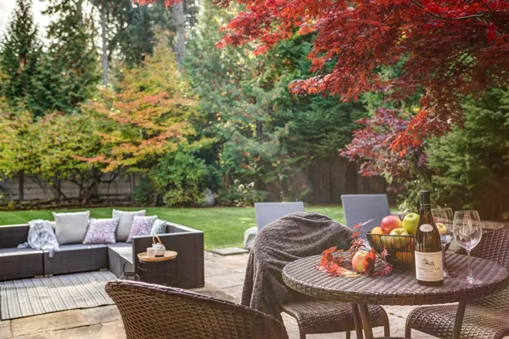 View of patio with view of scattered trees and an outdoor living space