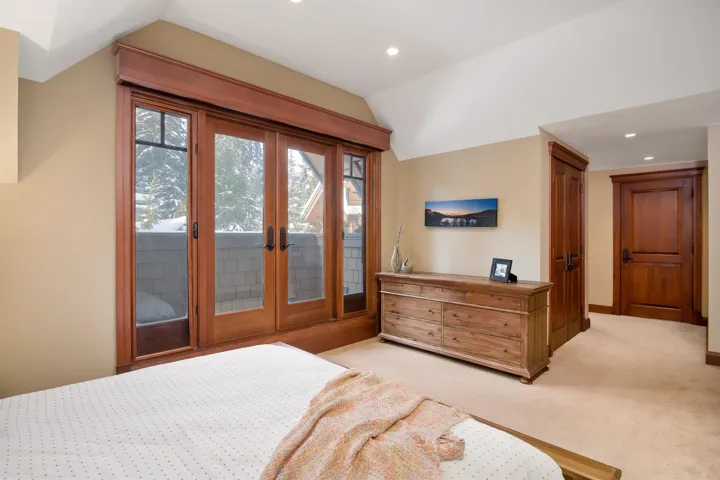 Bedroom 2 featuring vaulted ceiling, french doors, recessed lighting, and access to exterior