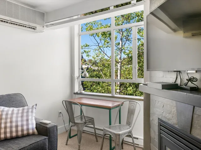 Living area featuring a mini split for heating / cooling and a wall mounted air conditioner