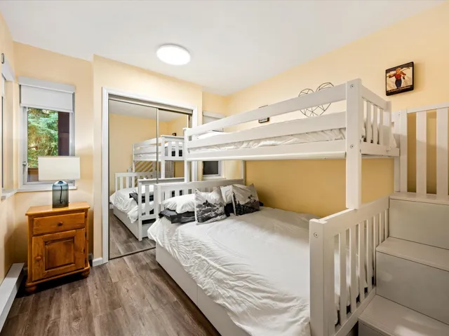Bedroom featuring dark wood finished floors and a closet