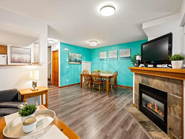Living room with wood finished floors and a fireplace