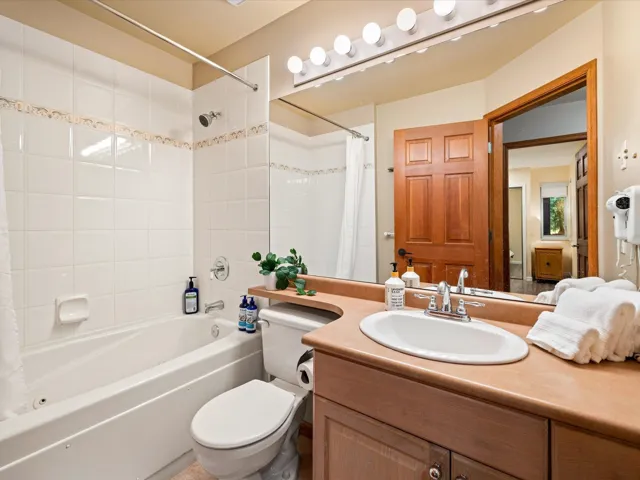 Bathroom with vanity and shower / bath combination with curtain