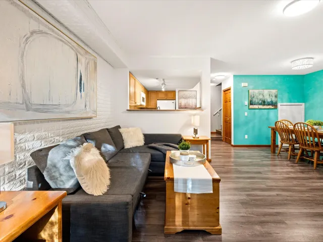Living room with dark wood-style floors and baseboards