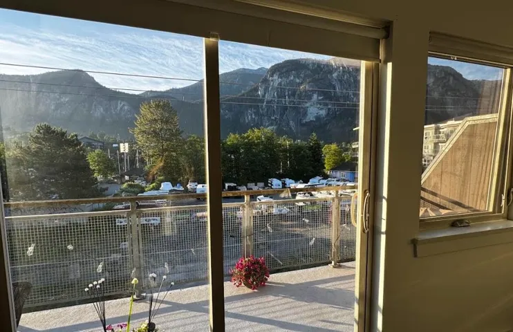Sliding glass door opening to an outdoor balcony with a metal mesh railing