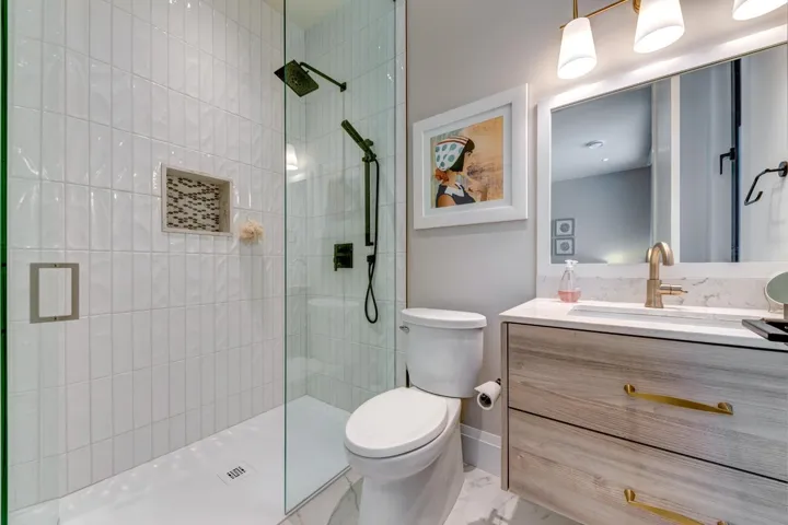 Bathroom with vanity, a walk in shower, and marble finish floors