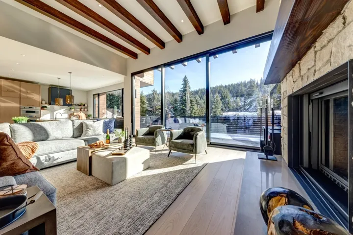 Living area featuring beamed ceiling, wood finished floors, and recessed lighting