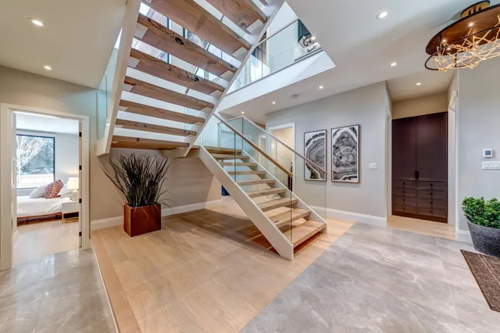 Stairway with recessed lighting and wood finished floors