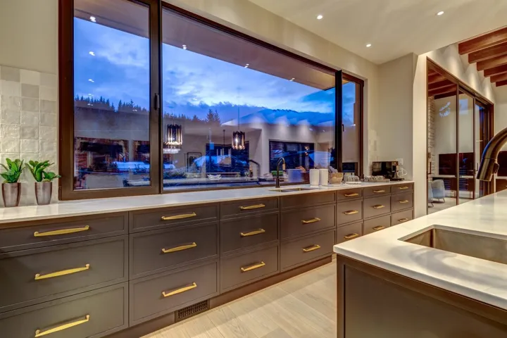 Bar featuring light wood-style floors and light stone counters