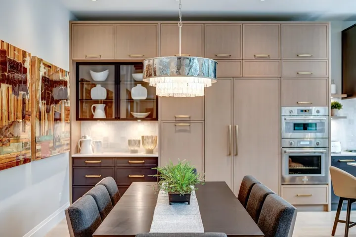 Kitchen featuring decorative backsplash, double oven, light wood-style flooring, and glass insert cabinets