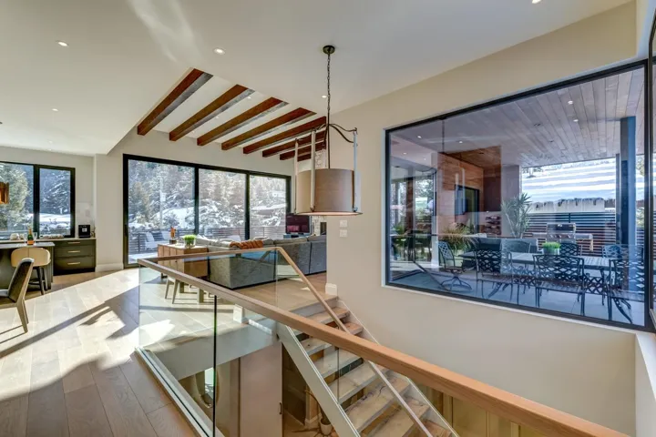 Stairway with beamed ceiling, wood finished floors, and recessed lighting
