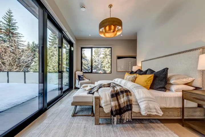 Bedroom with wood finished floors, access to exterior, and recessed lighting