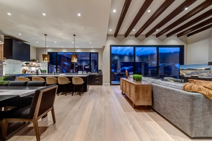 Living area with recessed lighting, beam ceiling, and light wood-style flooring