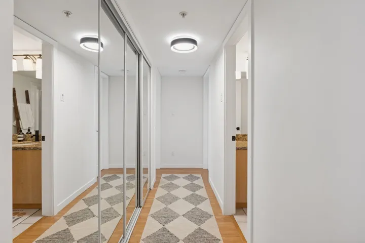 Corridor with baseboards and light wood-type flooring