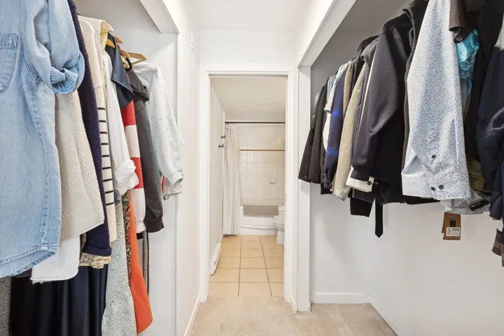 Spacious closet with light tile patterned floors
