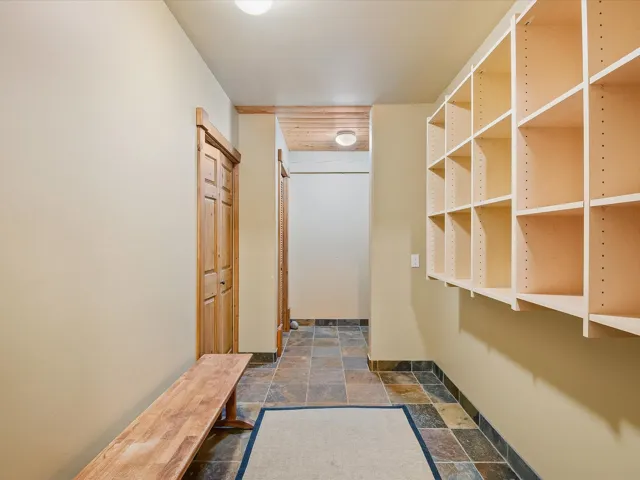 Interior space with stone tile flooring and baseboards