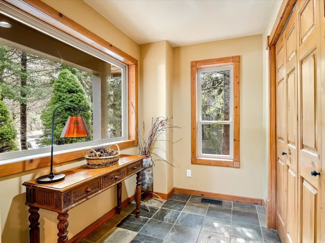 Doorway featuring baseboards, visible vents, and stone finish floor