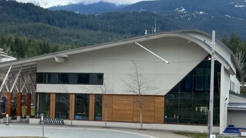 View of building exterior featuring a mountain view and a forest view