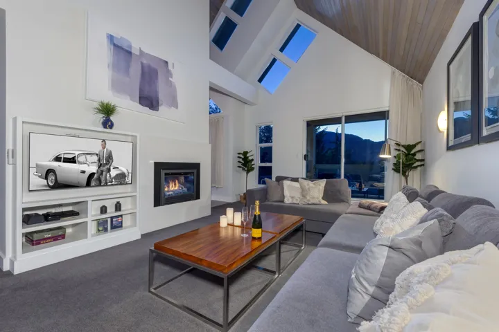 Vaulted ceiling with wood-finish paneling, skylights, and recessed lighting