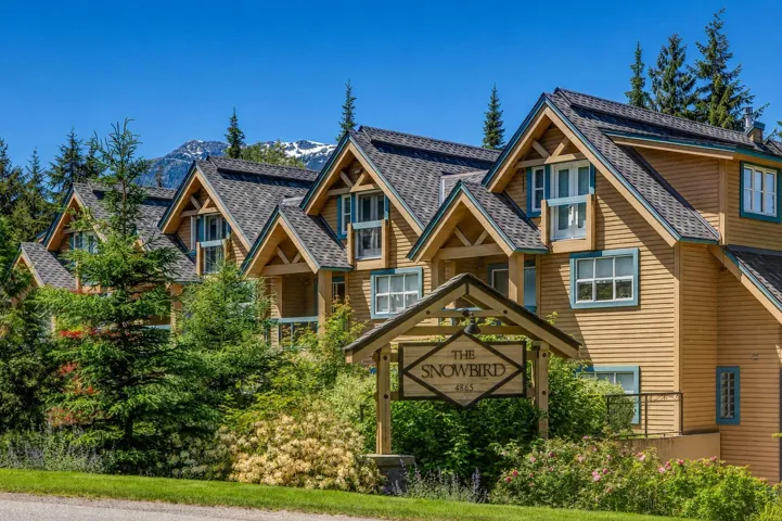 Multi-unit property featuring wood siding and gabled rooflines
