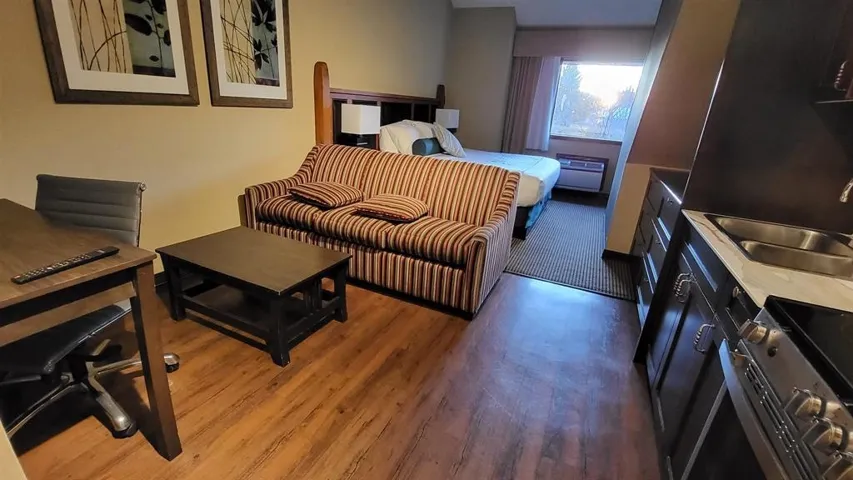 Bedroom with wood finished floors and a sink