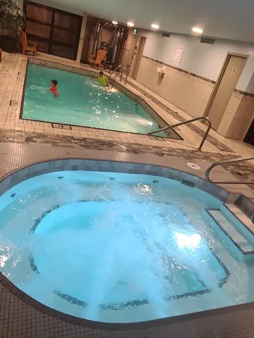 View of swimming pool featuring an indoor in ground hot tub