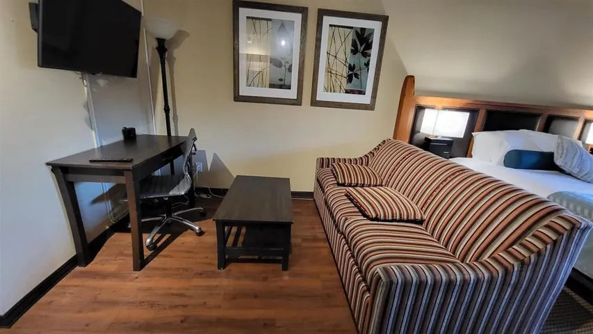Bedroom with baseboards and wood finished floors