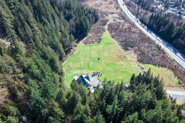 Aerial view of sparsely populated area with a forest