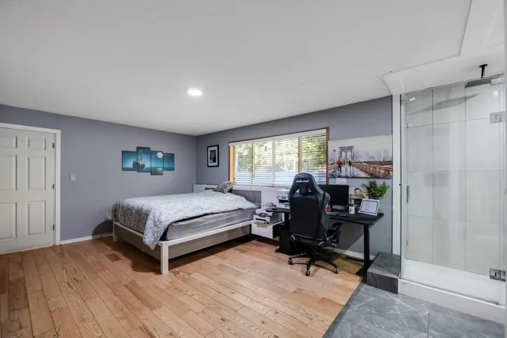 Bedroom featuring a desk and light wood finished floors