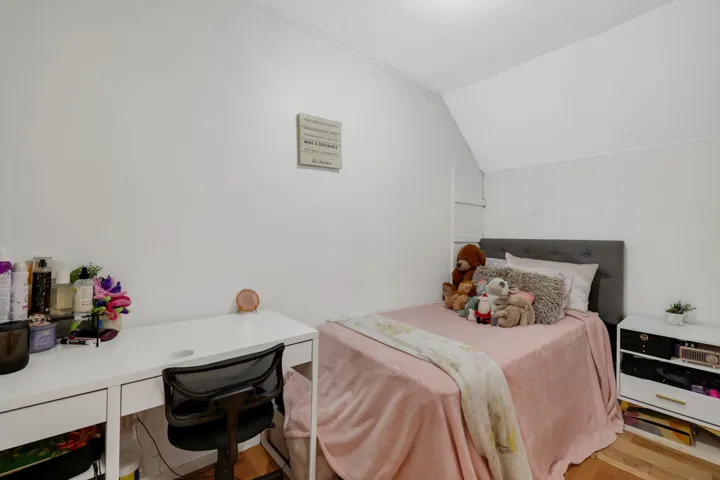 Bedroom featuring vaulted ceiling, a desk, and light wood finished floors