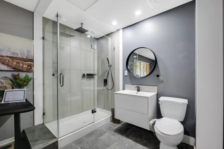 Bathroom with vanity, a shower stall, and recessed lighting