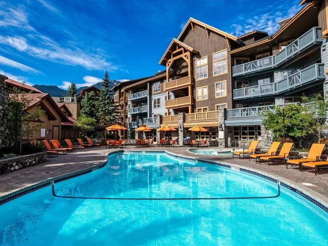 Community pool with a jacuzzi and a patio area