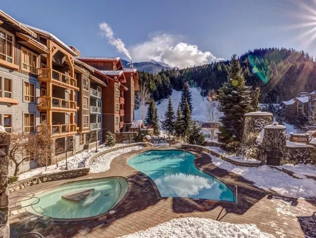 Community pool with a hot tub, a mountain view, and a patio area