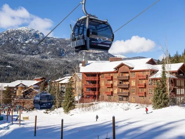 Snow covered building with a mountain view