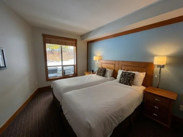 Bedroom featuring dark colored carpet and a textured ceiling