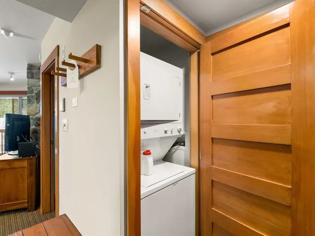 Laundry area with stacked washing machine and dryer