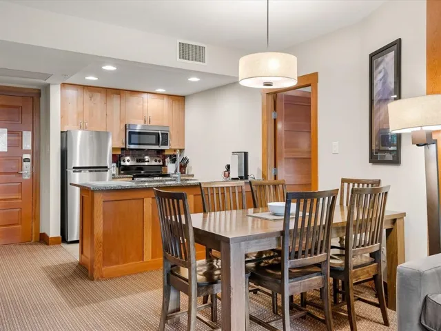 Dining space with recessed lighting and light colored carpet