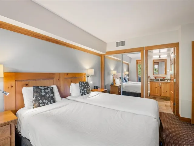 Bedroom with a closet, carpet flooring, and ensuite bathroom