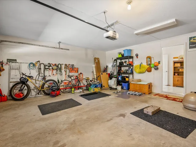 Garage with a garage door opener and bike storage