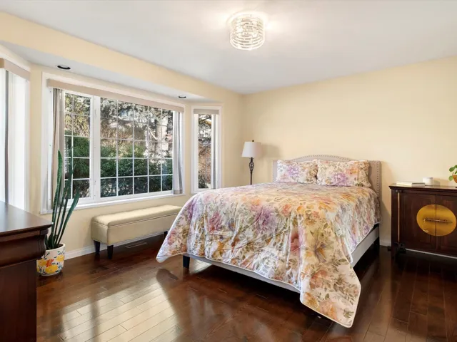 Bedroom featuring hardwood / wood-style flooring and baseboards