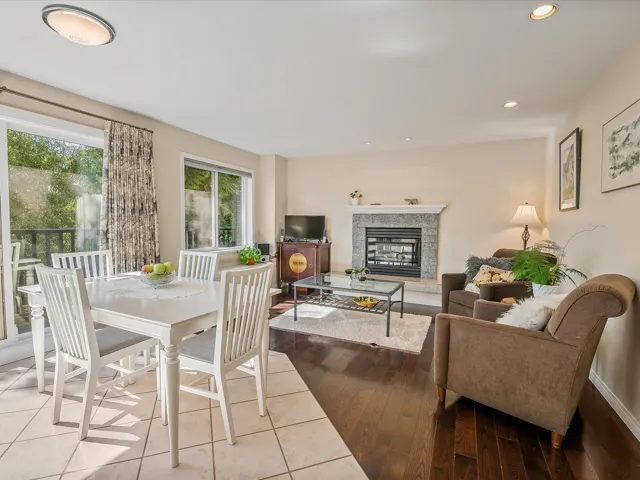 Dining area featuring a glass covered fireplace, recessed lighting, and wood-type flooring